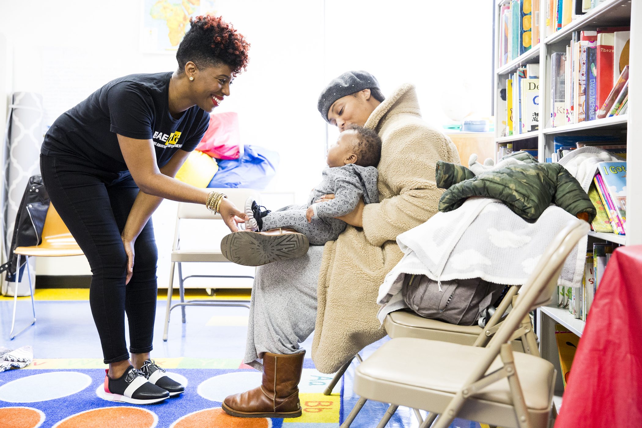 Lactation consultant Jabina Coleman (left) introduces herself to new mom Christine Smith and her fourth month old, Henry,