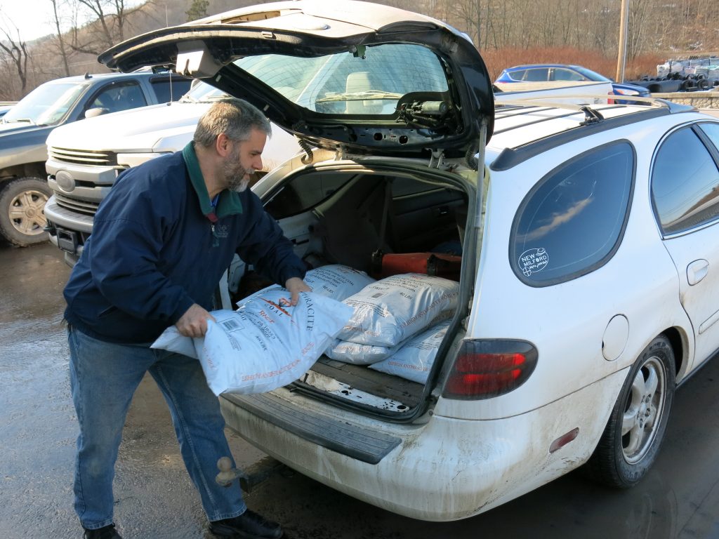 John Ord of Susquehanna, Pa., loads 40-pound bags of anthracite coal into his car. He's among the fewer than 130,000 households left in the United States that burn coal to heat their homes. (Jeff Brady/NPR)