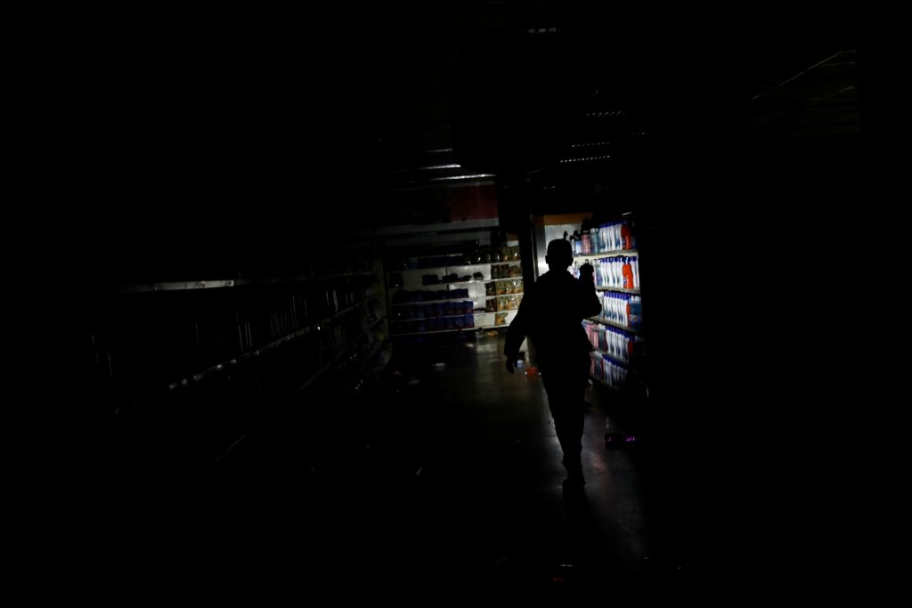 A worker inspects damage in a supermarket in Caracas on Sunday after it was looted during a days-long blackout in Venezuela. A worker inspects damage in a supermarket in Caracas on Sunday after it was looted during a days-long blackout in Venezuela.
(Carlos Garcia Rawlins/Reuters)