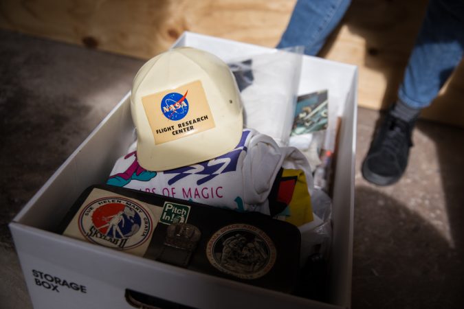 In addition to print photographs, the “space junk” collection includes, t-shirts, pins, buttons, patches, historical documents, stamps, “space bits” and other memorabilia.  (Lindsay Lazarski/WHYY)