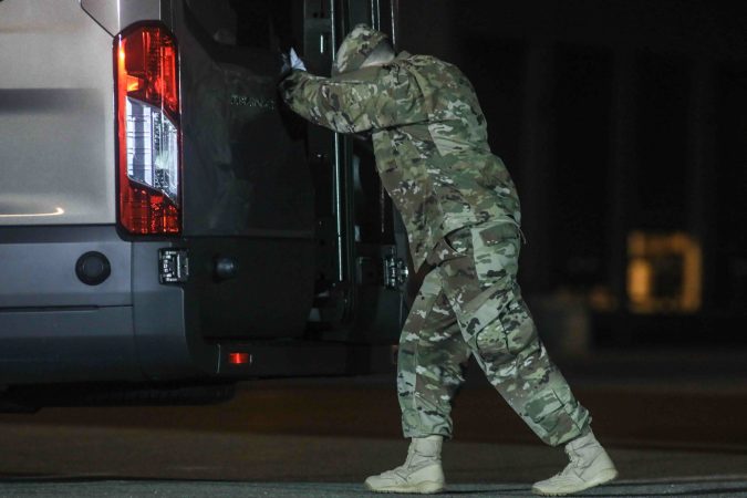 A U.S. Marine completes the transfer of the remains of Staff Sgt. Christopher K.A. Slutman during a dignified transfer at Dover Air Force Base Thursday, Apr. 11, 2019,Sgt. Slutman died April 8 while conducting combat operations in Parwan province, Afghanistan. (Saquan Stimpson for WHYY)