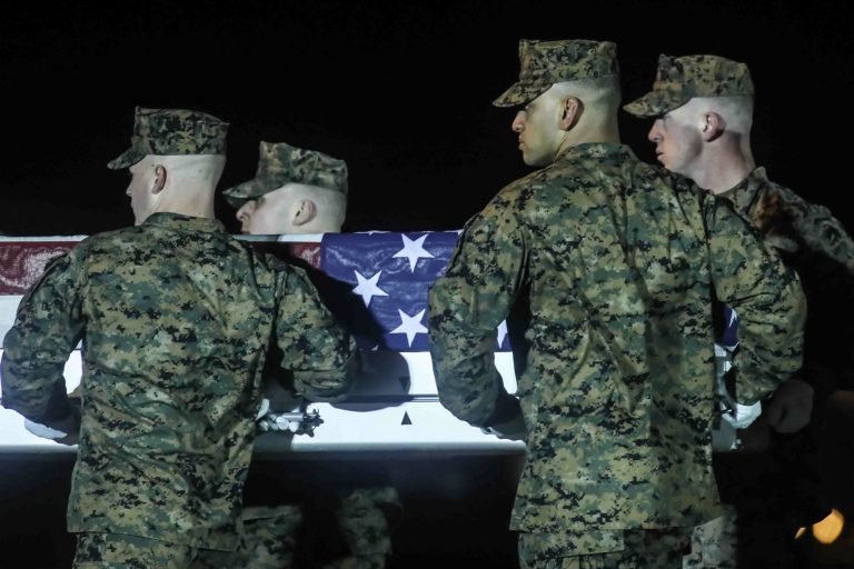 A U.S. Marine Corps carry team transfers the remains of Staff Sgt. Christopher K.A. Slutman, 43, of Newark, Delaware, during a dignified transfer at Dover Air Force Base Thursday, Apr. 11, 2019,  in Dover, DE. Sgt. Slutman died April 8 while conducting combat operations in Parwan province, Afghanistan. (Saquan Stimpson for WHYY)