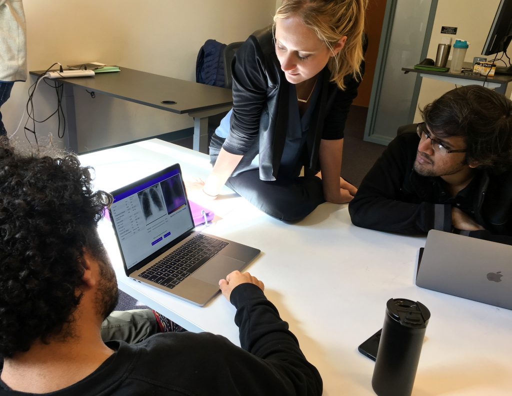 Amir Kiani (from left), Chloe O’Connell and Nishit Asnani troubleshoot an algorithm to diagnose tuberculosis in computer lab at Stanford University. Amir Kiani (from left), Chloe O'Connell and Nishit Asnani troubleshoot an algorithm to diagnose tuberculosis in computer lab at Stanford University.
(Richard Harris/NPR)