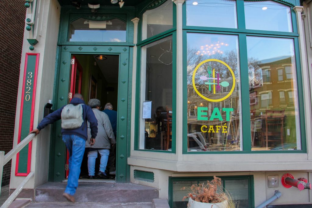 Patrons file into the EAT Café on Lancaster Avenue in University City. The pay-what-you-can restaurant will close on April 19 after 2 1/2 years in business. (Emma Lee/WHYY)
