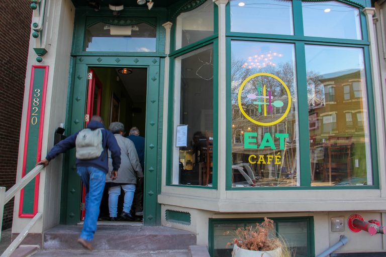 Patrons file into the EAT Café on Lancaster Avenue in University City. The pay-what-you-can restaurant will close on April 19 after 2 1/2 years in business. (Emma Lee/WHYY)