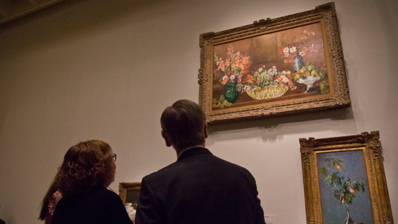Visitors admire “Still Life with Flowers and Fruit” by Pierre-Auguste Renoir at the “The Impressionist’s Eye” exhibit at the Philadelphia Museum of Art. (Kimberly Paynter/WHYY)