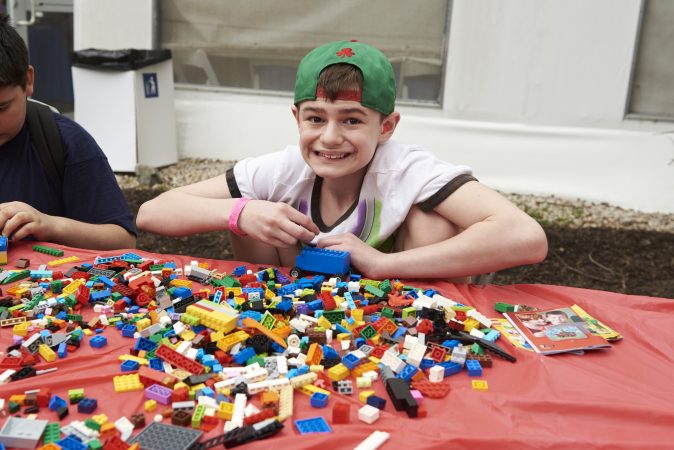 Brayden Tiscio, 12, builds a lego truck at the Lego table at the 20th Annual Autism Awareness Day event at the Philadelphia Zoo.  Brayden was diagnosed with Autism when he was three. (Natalie Piserchio for WHYY)