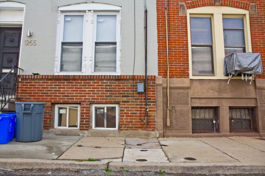 2019 04 15 1200 taylor-2 Sidewalks are shown on a block with rowhomes that are slanted and cracked.