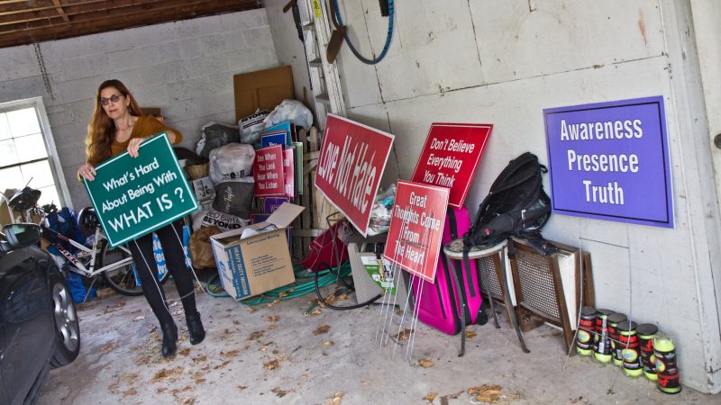 Meg Miller stores her signs in her garage, replacing the one in her yard every few weeks. (Kimberly Paynter/WHYY)