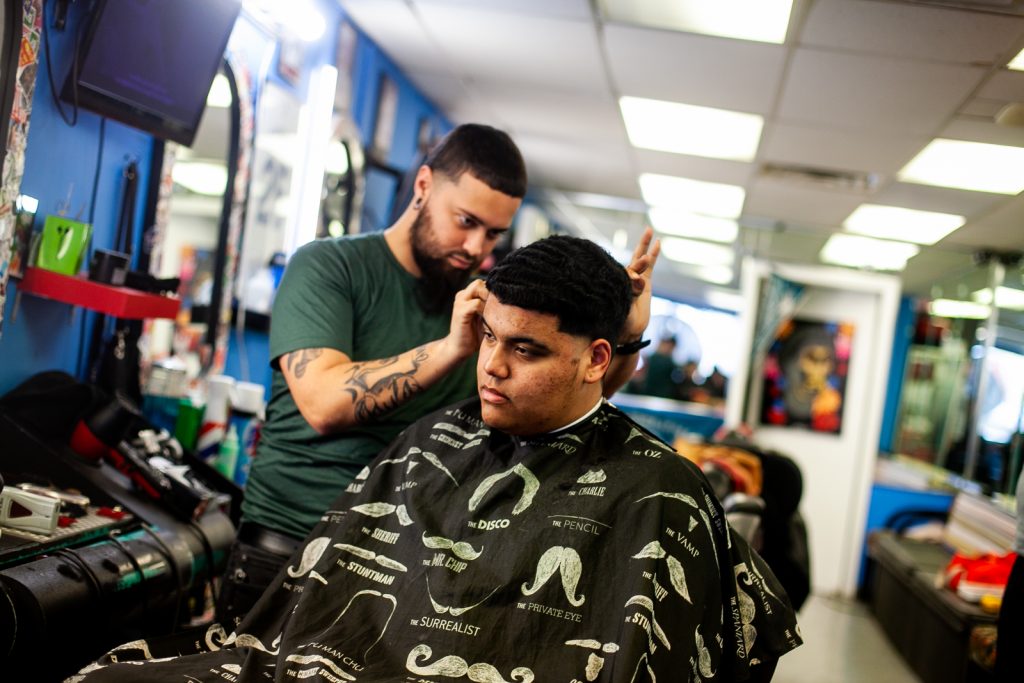 2019 3 7- b larrison- philadelphia- views from resdients of fairhill on state of the city as jim kenneys campaign for relection approaches -68 Bryan Romero has his hair cut by barber Jojo at Vibes barber shop on fifth street in the Fairhill section of Philadelphia. (Brad Larrison for WHYY)