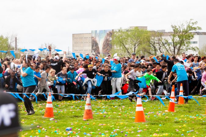 Following the Easter Egg drop children ran to collect them at the River Fields in Northeast Philadelphia. (Brad Larrison for WHYY)