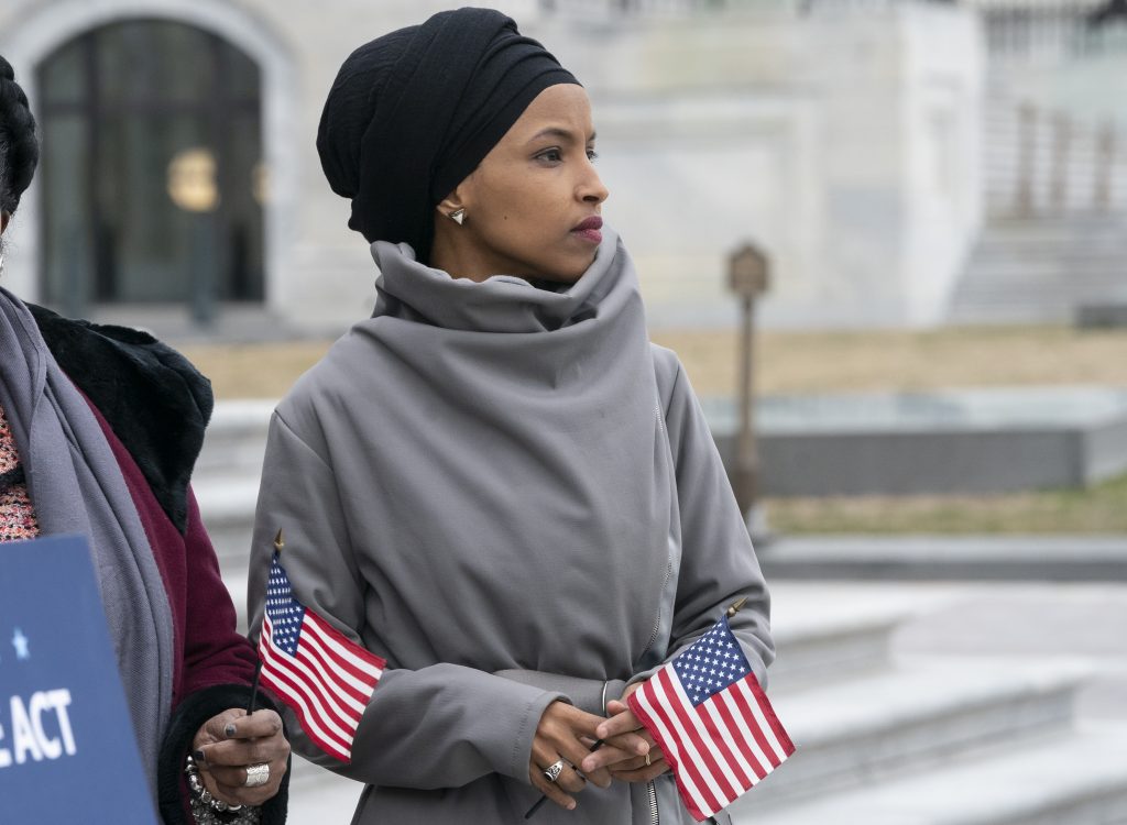 Ilhan Omar Rep. Ilhan Omar, D-Minn., stands with fellow Democrats as they rally outside the Capitol ahead of passage of H.R. 1,
