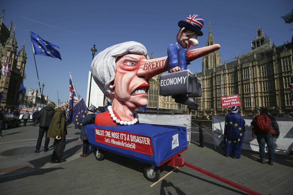 Britain Brexit Anti-Brexit demonstrators with an effigy of British Prime Minister Theresa May near College Green at the Houses of Parliament in London, Monday, April 1, 2019. (Jonathan Brady/PA via AP)