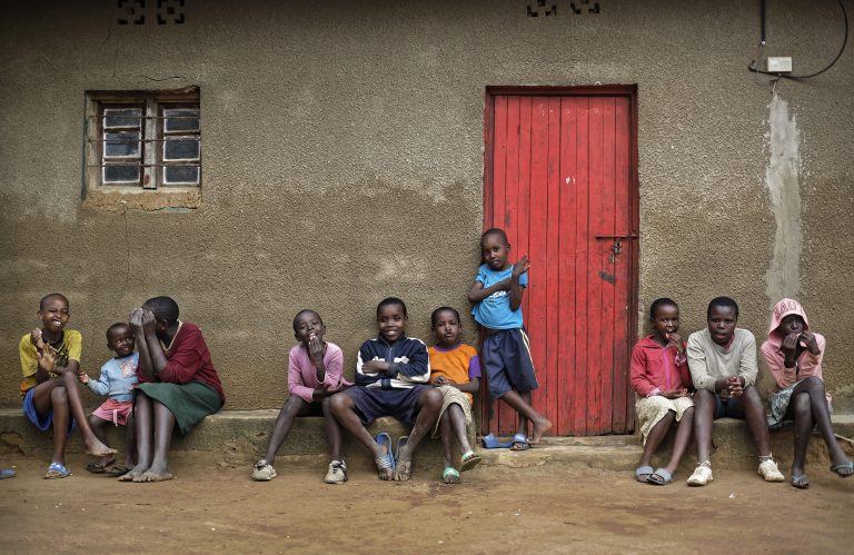 In this photo taken Thursday, April 4, 2019, the children of genocide survivors and perpetrators play together in the reconciliation village of Mbyo, near Nyamata, in Rwanda. Twenty-five years after the genocide the country has six 
