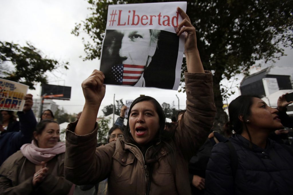 Ecuador Wikileaks Assange Arrest A woman holds up the Spanish hashtag #Freedom during a protest against the arrest of WikiLeaks founder Julian Assange, outside the Foreign Ministry in Quito, Ecuador, Thursday, April 11, 2019. On Thursday, Ecuador's President Lenin Moreno allowed British authorities to forcibly remove Assange from Ecuador’s small embassy in London where he was given safe haven in 2012. (Dolores Ochoa/AP Photo)