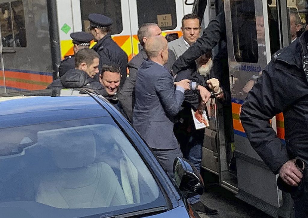 Britain Wikileaks Assange Arrested Police bundle WikiLeaks founder Julian Assange from the Ecuadorian embassy into a police van in London after he was arrested by officers from the Metropolitan Police and taken into custody Thursday April 11, 2019. (@DailyDOOH via AP)