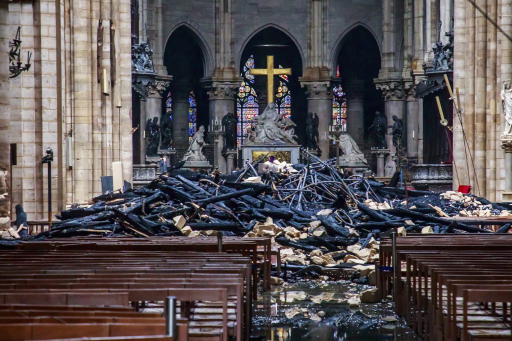 APTOPIX France Notre Dame Fire A hole is seen in the dome inside Notre Dame cathedral in Paris, Tuesday, April 16, 2019. Firefighters declared success Tuesday in a more than 12-hour battle to extinguish an inferno engulfing Paris' iconic Notre Dame cathedral that claimed its spire and roof, but spared its bell towers and the purported Crown of Christ. (Christophe Petit Tesson, Pool via AP)