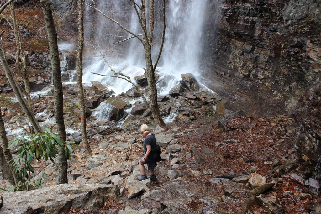 Popular Hiking Trail Closure An unidentified woman makes her way to the base of a waterfall