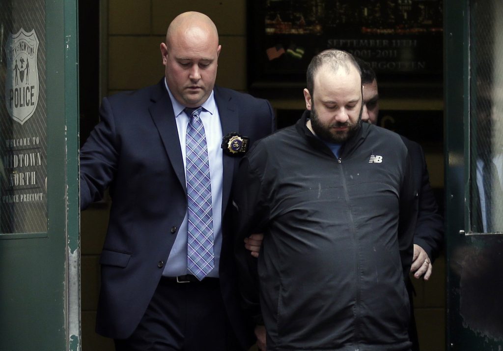 Marc Lamparello Marc Lamparello, 37, (center), is escorted out of a police precinct in New York, Thursday, April 18, 2019. Police say Lamparello was arrested after entering St. Patrick's Cathedral Wednesday night in New York with two cans of gasoline, lighter fluid and butane lighters. (Seth Wenig/AP Photo)