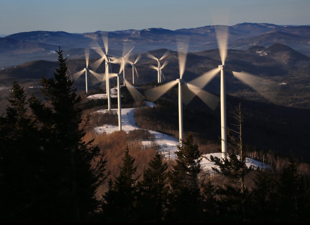 Legislatures Going Green In this Tuesday, March 19, 2019 photo, the blades of wind turbines catch the breeze at the Saddleback Ridge wind farm in Carthage, Maine. (Robert F. Bukaty/AP Photo)