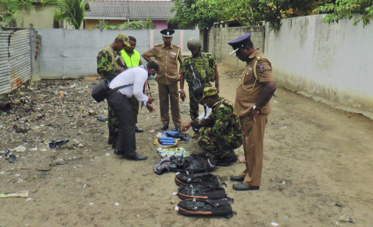 Sri Lankan police and army officers display gelatin sticks, detonators, back packs and other bomb making material recovered from the hide out of militants after Friday's gun battle in Kalmunai, in eastern Sri Lanka Sri Lanka, Saturday, April 27, 2019. Militants linked to Easter suicide bombings opened fire and set off explosives during a raid by Sri Lankan security forces on a house in the country's east, leaving behind 15 bodies, including six children. (Achala Upendra/AP Photo)