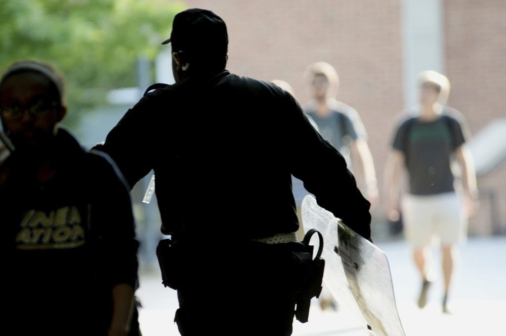 College Campus Shooting North Carolina A University of North Carolina, Charlotte campus police officer carries a tactical shield after a shooting Tuesday afternoon, April 30, 2019, in Charlotte, N.C. The shooting on the campus left at least a few people dead and several wounded Tuesday, prompting a lockdown and chaotic scene in the state's largest city. (John Simmons/The Charlotte Observer via AP)
