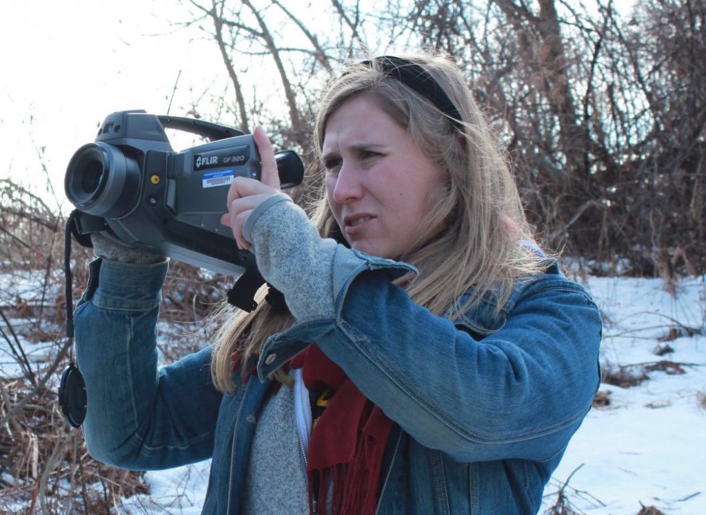IMG_52281-e1556058976927-1920×775 Researcher Melissa Sullivan uses an infrared FLIR camera to determine if methane is leaking from a well site. (Susan Phillips/StateImpact Pennsylvania)