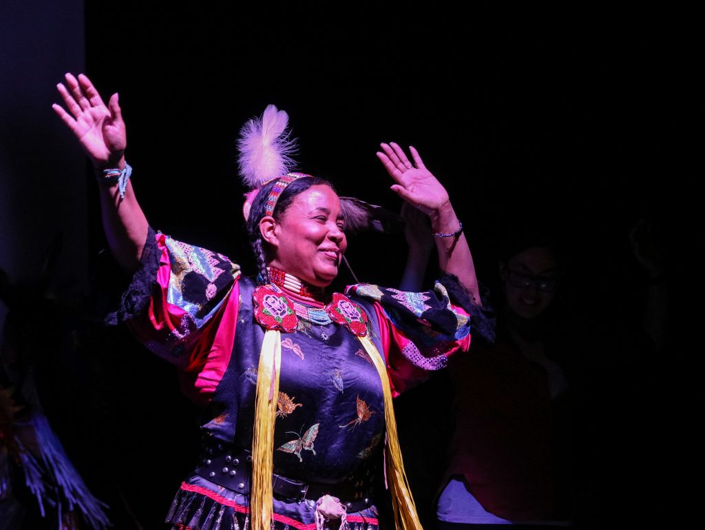 SEEDS9 Vaughnda Hilton, founder of the indigenous dance troupe Native Nations Dance Theater, celebrates with audience members during a friendship dance (Angela Gervasi for WHYY)