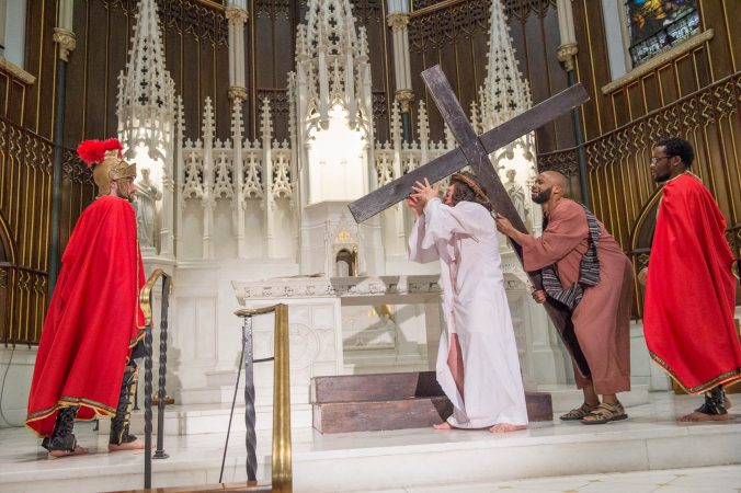Simon the Cyrene played by Langston Massey-Jefferson helps Jesus carry the cross at the 5th Station of the Cross. (Jonathan Wilson for WHYY)