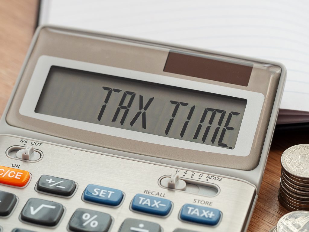 Tax Time Word On Calculator. Business And Tax Concept. Time To P (Bigstock/ieang)