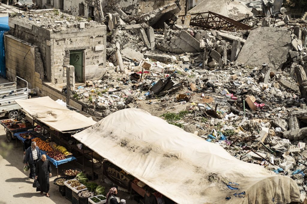 Customers walk near makeshift fruit and vegetable shops set in front of destroyed buildings in the northern Syrian city of Raqqa earlier this month. Customers walk near makeshift fruit and vegetable shops set in front of destroyed buildings in the northern Syrian city of Raqqa earlier this month. (Delil Souleiman /AFP/Getty Images)