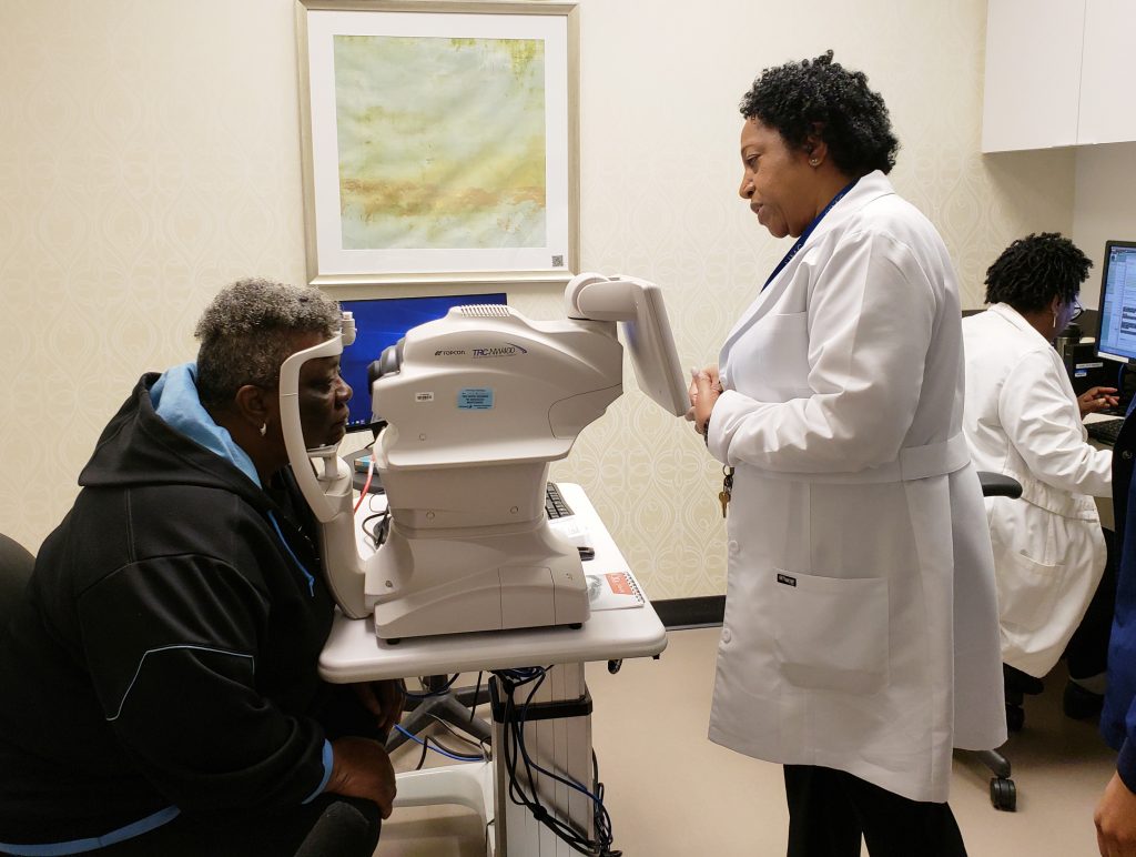 Nurse practitioner Debra Brown guides patient Merdis Wells through a diabetic retinopathy exam at University Medical Center in New Orleans. Nurse practitioner Debra Brown guides patient Merdis Wells through a diabetic retinopathy exam at University Medical Center in New Orleans. (Courtesy of IDx)