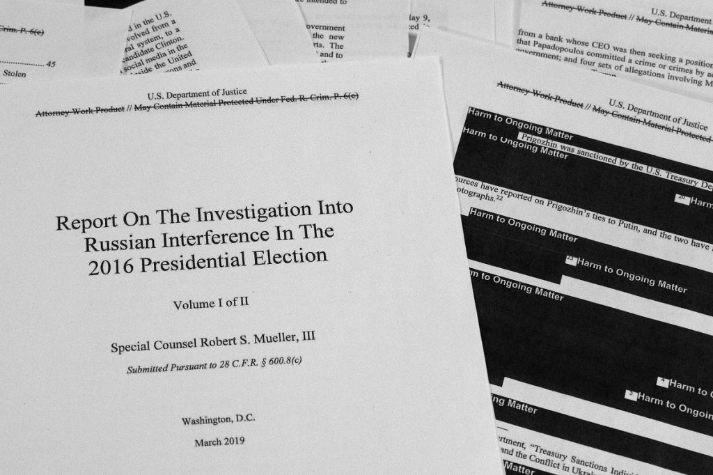 Trump Russia Probe Special counsel Robert Mueller's redacted report on Russian interference in the 2016 presidential election as released on Thursday, April 18, 2019, is photographed in Washington. (AP Photo/Jon Elswick)