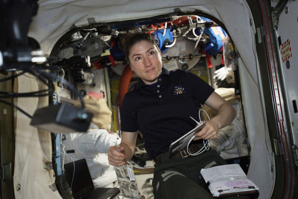 Near Year in Space NASA astronaut and Expedition 59 Flight Engineer Christina Koch works on U.S. spacesuits inside the Quest airlock.
