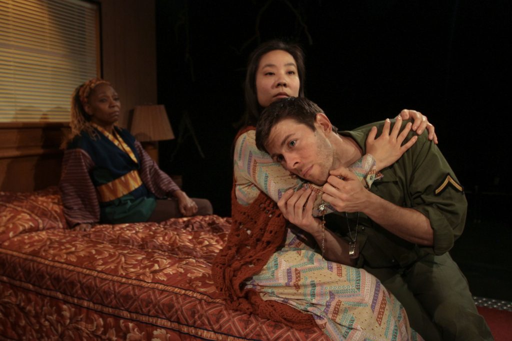 111 Cathy Simpson (rear left) as Jesus, Bi Jean Ngo and James Kern as daughter and father in Theatre Exile's production of