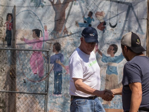 As another building session draws to a close, Kevin Lally (right) shakes the hand of a new volunteer. (Angela Gervasi for WHYY)