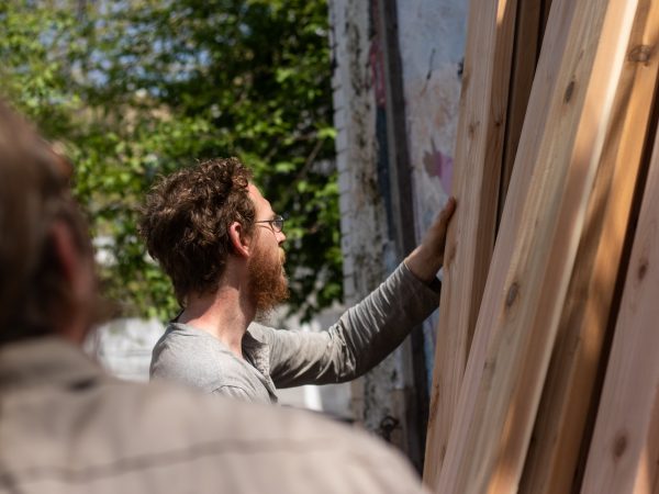 Willow Zef gathers lumber to begin building elevated garden beds. Zef also volunteers at the César Andreu Iglesias Community Garden on Lawrence and Norris streets. (Angela Gervasi for WHYY)