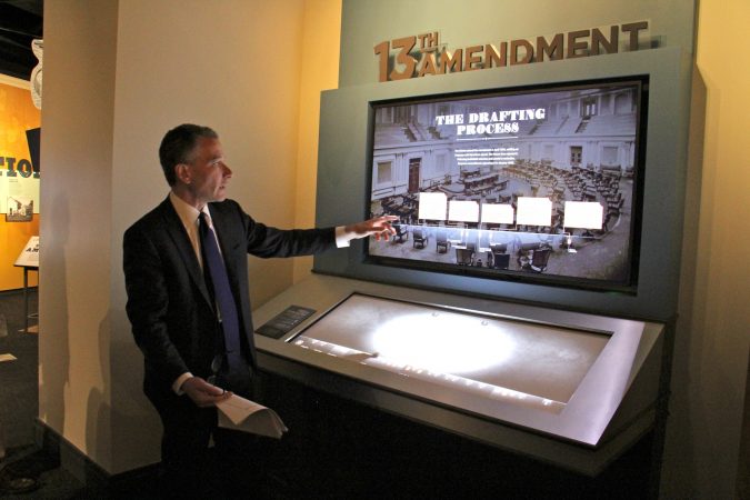 National Constitution Center President Jeffrey Rosen demonstrates one of the interactive exhibits in the center's new show, 