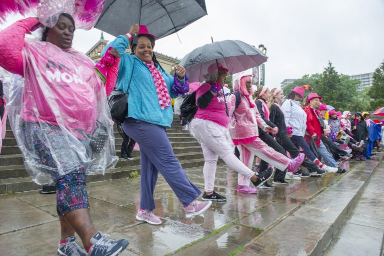 Breast cancer survivors dance on the steps of the Philadelphia Museum of Art. (Jonathan Wilson for WHYY)