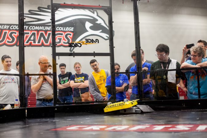 Pre-Swiss Cheese, a robot fielded by Upper Bucks County Technical School competes against MaST Community Charter School's robot Mcnasty during the Liberty Bots competiton Saturday at Montgomery County Community College. (Brad Larrison for WHYY)