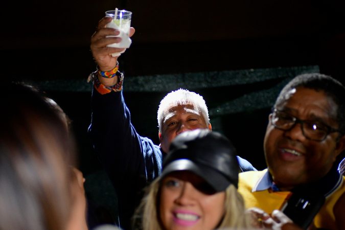 A glass is raised as Maria Quiñones-Sanchez gives a victory speech surrounded by family, friends and supporters. (Bastiaan Slabbers for WHYY)