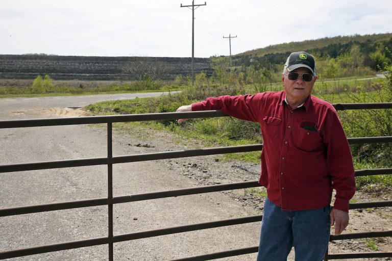 Tim Tanksley, one of the few local people still fighting after years of trying to convince Oklahoma lawmakers to crack down on the coal ash dumping, stands outside a dump site Monday, April 8, 2019, in Bokoshe, Okla.(Sue Ogrocki/AP Photo)