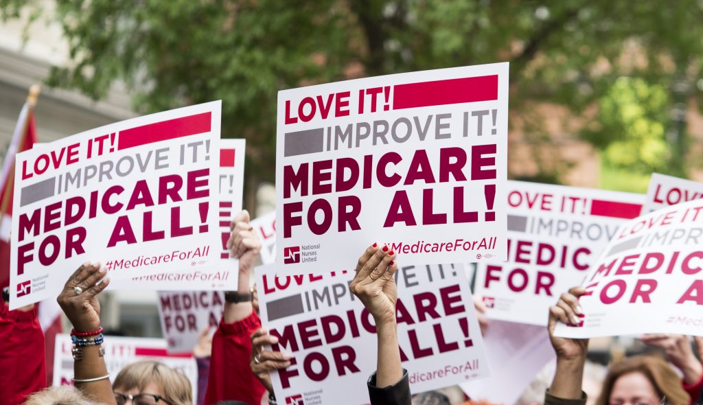 Medicare for All Members of National Nurses United union members wave 'Medicare for All' signs during a rally in front of the Pharmaceutical Research and Manufacturers of America in Washington calling for 'Medicare for All' on Monday, April 29, 2019. (Photo By Bill Clark/CQ Roll Call via AP Images)