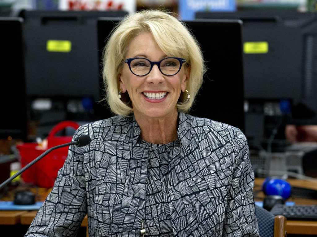 Betsy DeVos In this May 31, 2018, file photo, Education Secretary Betsy DeVos speaks during a visit of the Federal School Safety Commission at Hebron Harman Elementary School in Hanover, Md. Education, it’s safe to say, is not President Donald Trump’s top priority. Instead, he entrusts that realm to Education Secretary Betsy DeVos, who after two years has emerged as one of the most polarizing figures in the Cabinet but also one of its most enduring members. (Jose Luis Magana/AP Photo)