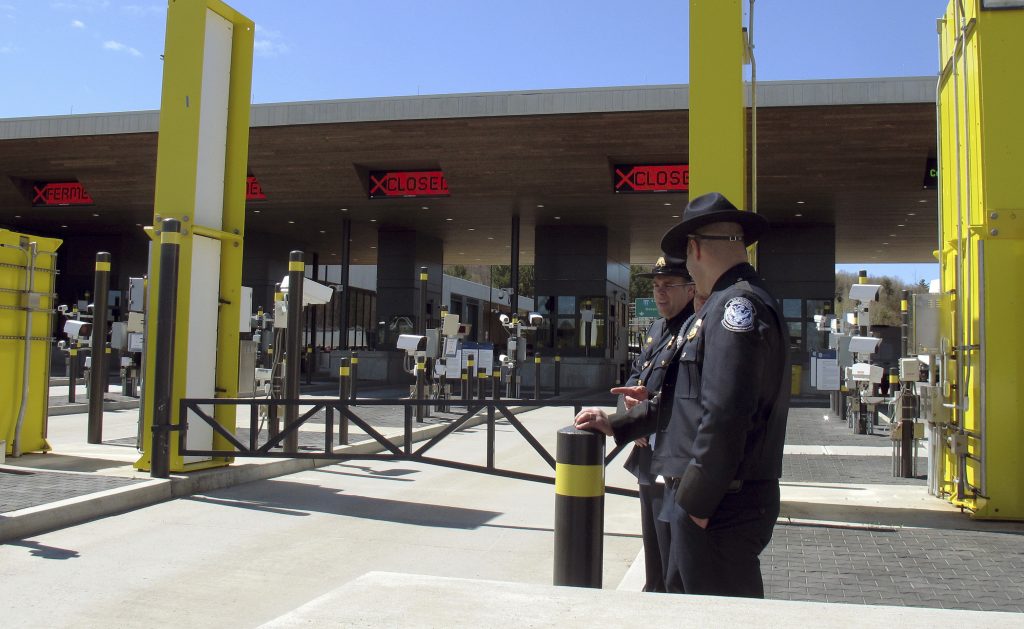Northern Border Delays In this May 8, 2019 photo, U.S. Customs and Border Protection officials stand at the new border crossing facility on the U.S.-Canadian border in Derby Line, Vt. Some along the northern U.S. border are worried the temporary transfer of hundreds of border agents south could cause backups of people seeking to enter the United States from Canada during the busy summer tourist season. (Wilson Ring/AP Photo)