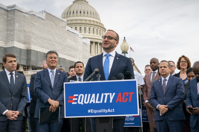 Chad Griffin, president of the Human Rights Campaign, flanked by Rep. Mark Takano, D-Calif., (left), and Rep. David Cicilline, D-R.I., speaks to advocates for LGBTQ rights as they rally before a vote in the House on the 'Equality Act of 2019,' sweeping anti-discrimination legislation that would extend civil rights protections to LGBT people by prohibiting discrimination based on sexual orientation or gender identity, at the Capitol in Washington, Friday, May 17, 2019. Cicilline is the chief sponsor of the bill to protect LGBTQ rights. (J. Scott Applewhite/AP Photo)