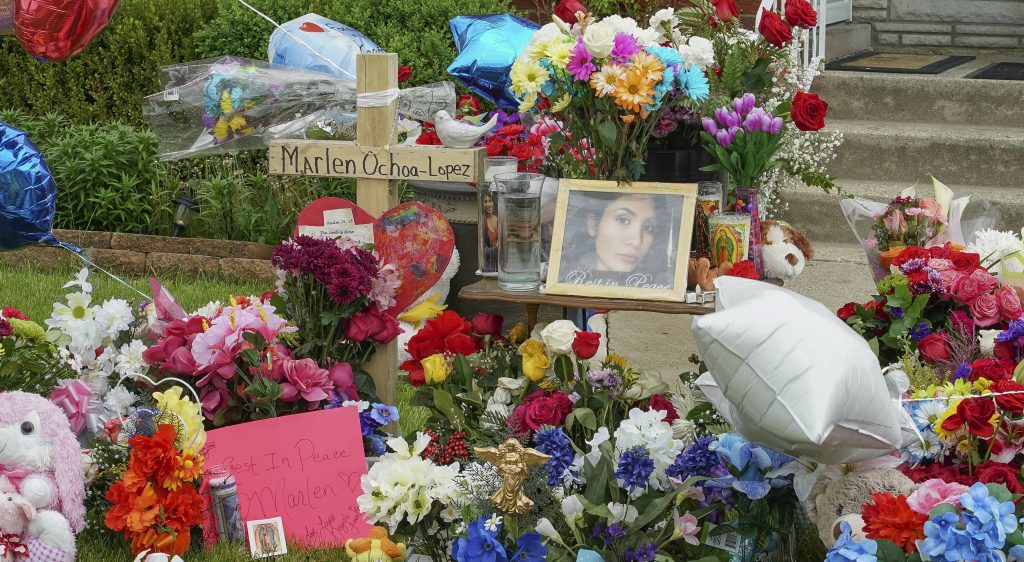James Murphy A memorial of flowers, balloons, a cross and photo of victim Marlen Ochoa-Lopez, are displayed on the lawn, Friday, May 17, 2019 in Chicago, outside the home where Ochoa-Lopez was murdered last month. Assistant State's Attorney James Murphy says a pregnant Ochoa-Lopez, who was killed and whose baby was cut from her womb, was strangled while being shown a photo album of the late son and brother of her attackers. (Teresa Crawford/AP Photo)