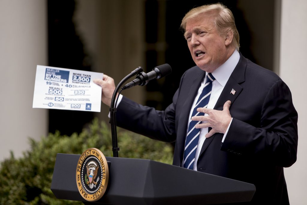President Donald Trump holds up a stat sheet having to do with the Mueller Report as he speaks in the Rose Garden at the White House in Washington, Wednesday, May 22, 2019. (Andrew Harnik/AP Photo)