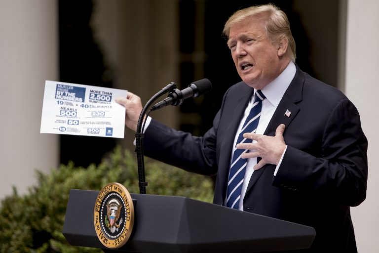 President Donald Trump holds up a stat sheet having to do with the Mueller Report as he speaks in the Rose Garden at the White House in Washington, Wednesday, May 22, 2019. (Andrew Harnik/AP Photo)