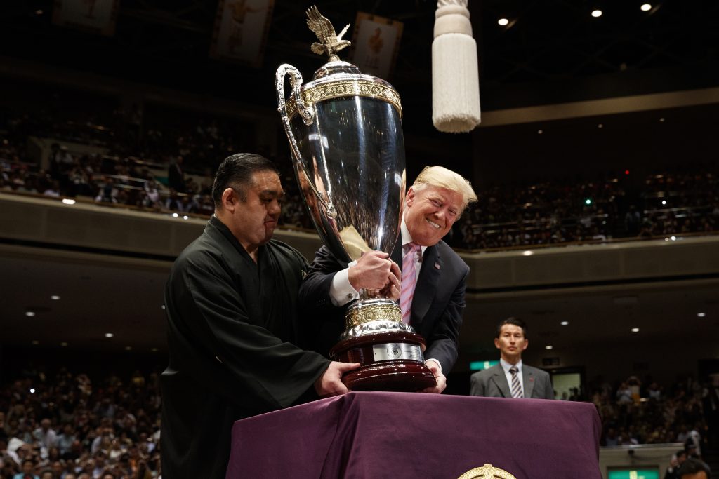 Donald Trump President Donald Trump picks up the 'President's Cup' to present to the Tokyo Grand Sumo Tournament winner Asanoyama, at Ryogoku Kokugikan Stadium, Sunday, May 26, 2019, in Tokyo. (Evan Vucci/AP Photo)